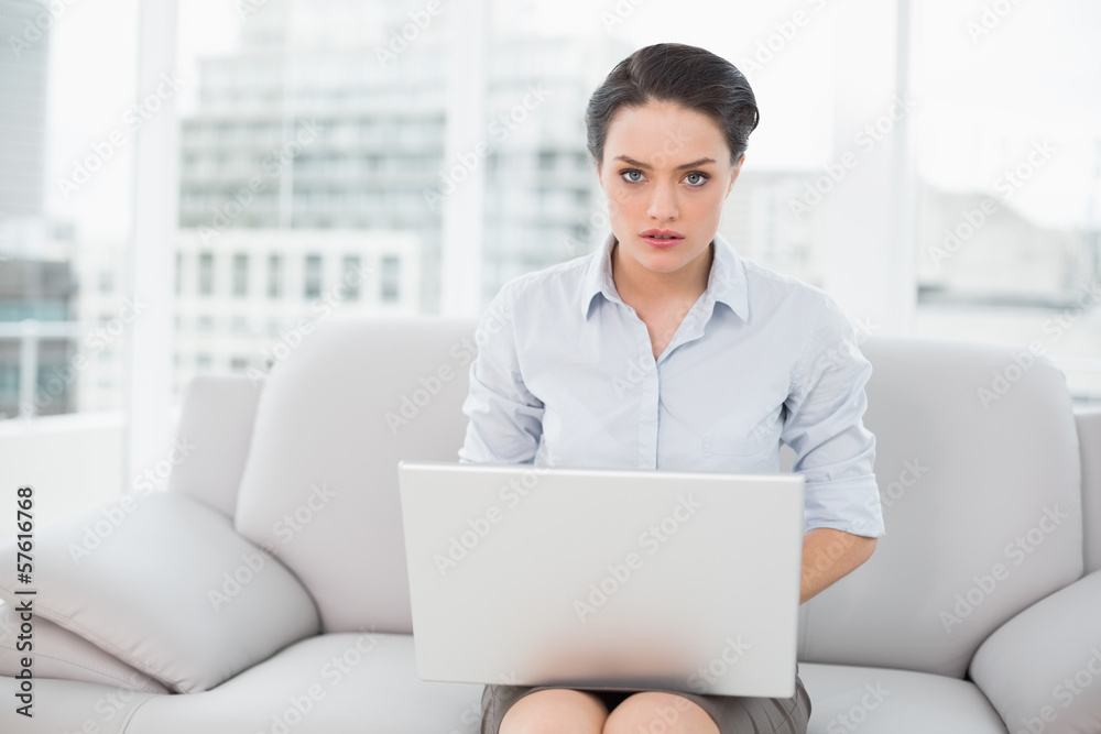 Well dressed young woman using laptop at home Well dressed young woman using laptop at home
