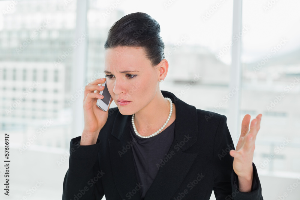 Serious elegant businesswoman using cellphone Serious elegant businesswoman using cellphone