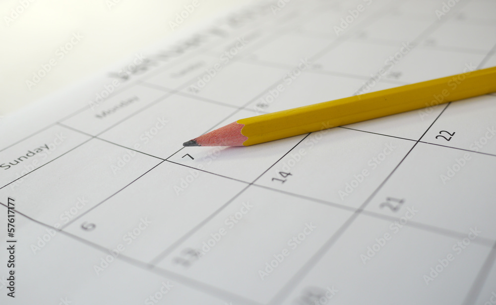 pencil lying on a calendar pencil lying on a calendar