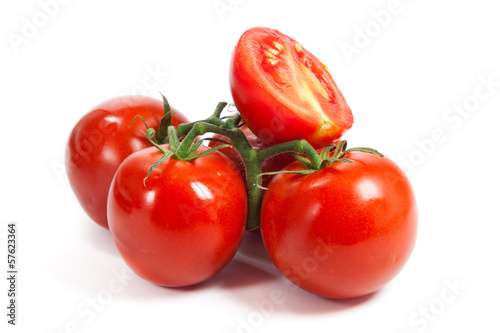 Closeup of tomatoes on the vine isolated on white. Tomato branch © EwaStudio