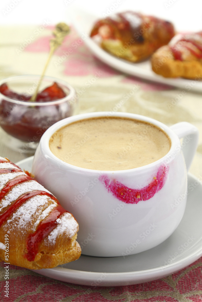 1874. Cup of coffee with lipstick mark and croissant with strawb 1874. Cup of coffee with lipstick mark and croissant with strawb