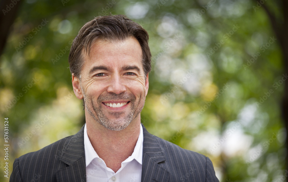 Portrait Of A Successul Businessman Smiling At The Camera Portrait Of A Successul Businessman Smiling At The Camera