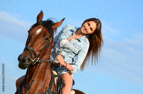 The woman on a horse against the sky