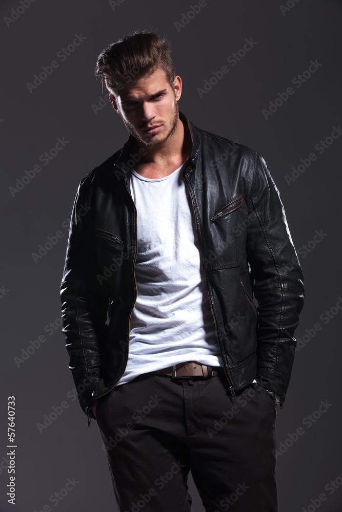 man in leather jacket posing with his hands in pockets man in leather jacket posing with his hands in pockets