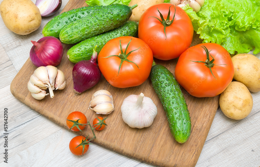 fresh vegetables on a cutting board on a wooden table