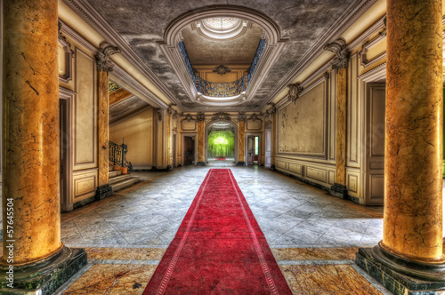 Red carpet in the hallway of an abandoned manor
