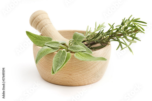 mortar and pestle with sage and rosemary photo