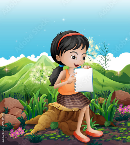 A girl sitting above a stump with a notebook