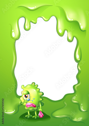 A border design with a green monster in tears