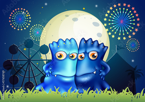 Two blue monsters holding each other at the park
