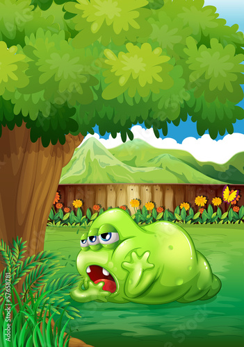 A tired green monster near the tree