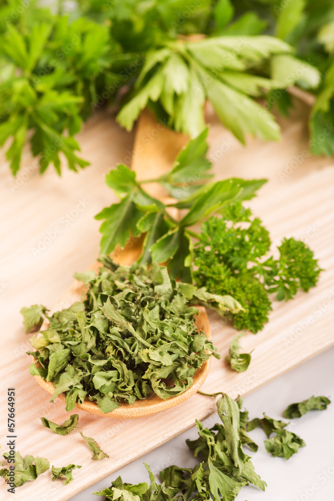 Dried herbs parsley and celery on a wooden spoon. Dried herbs parsley and celery on a wooden spoon.