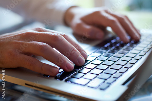 hands of business man type on the keyboard of computer