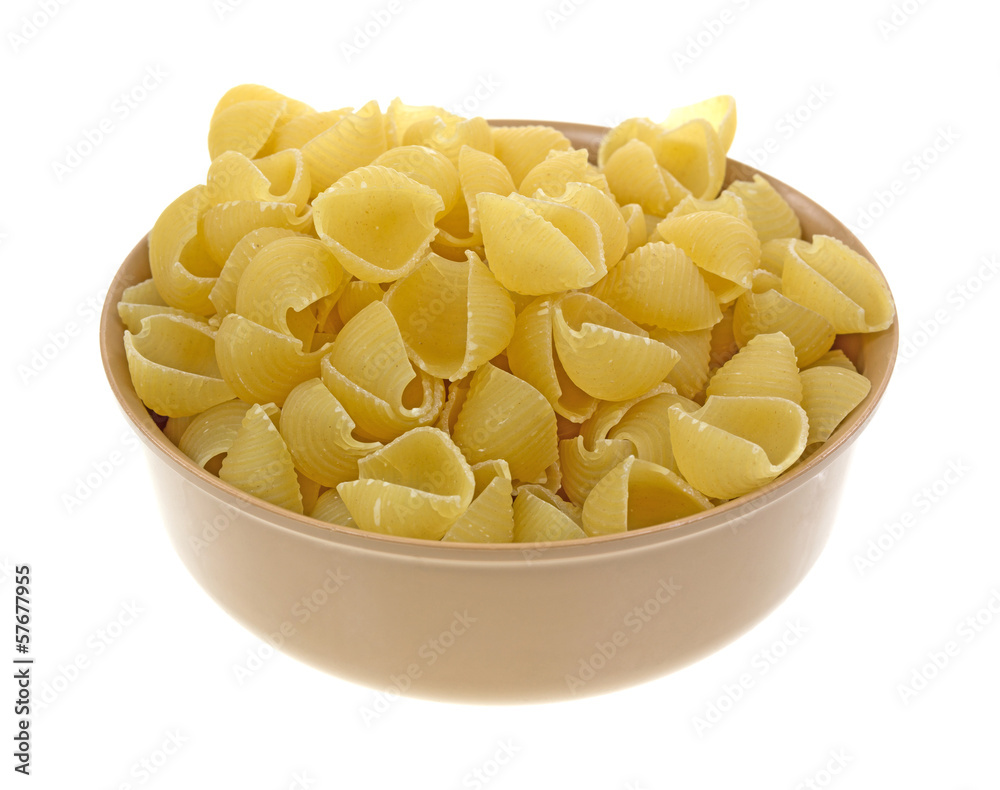 Small pasta shells in a tan bowl Small pasta shells in a tan bowl