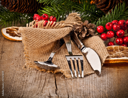 Vintage silverware on rustic wooden background with christmas de