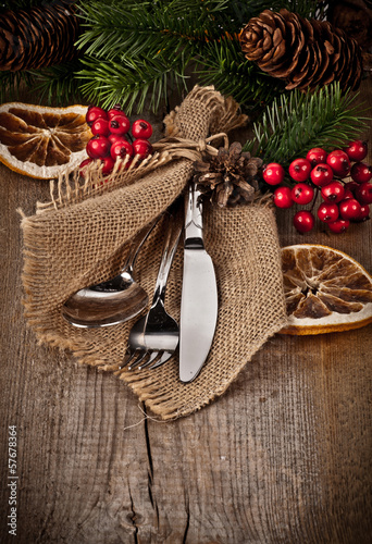 Vintage silverware on rustic wooden background with christmas de