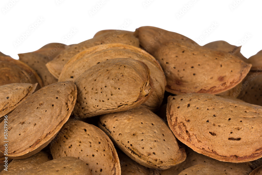 Heap of almond nuts isolated on white background