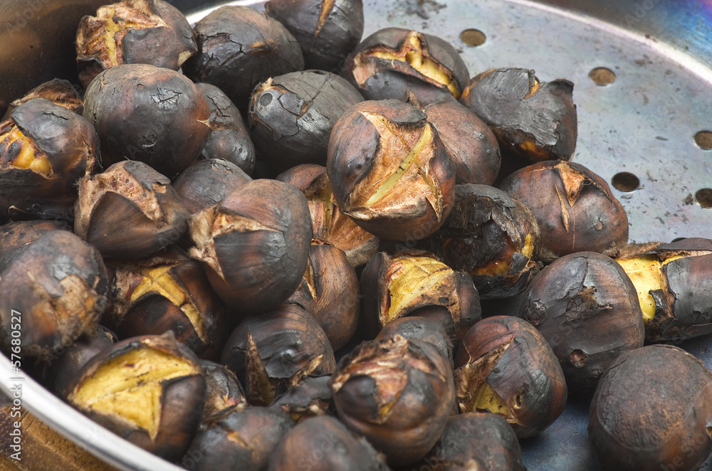 Delicious roasted chestnuts group in a pot Delicious roasted chestnuts group in a pot