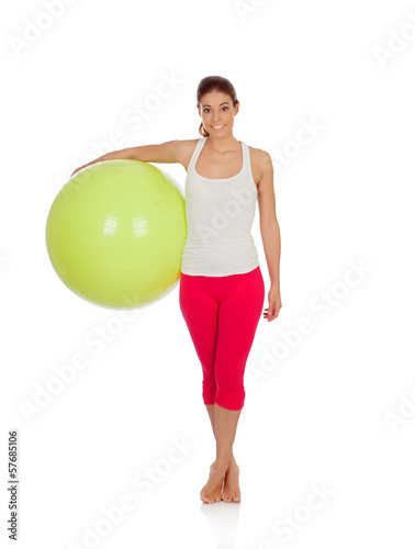 Attractive woman doing pilates with a big green ball