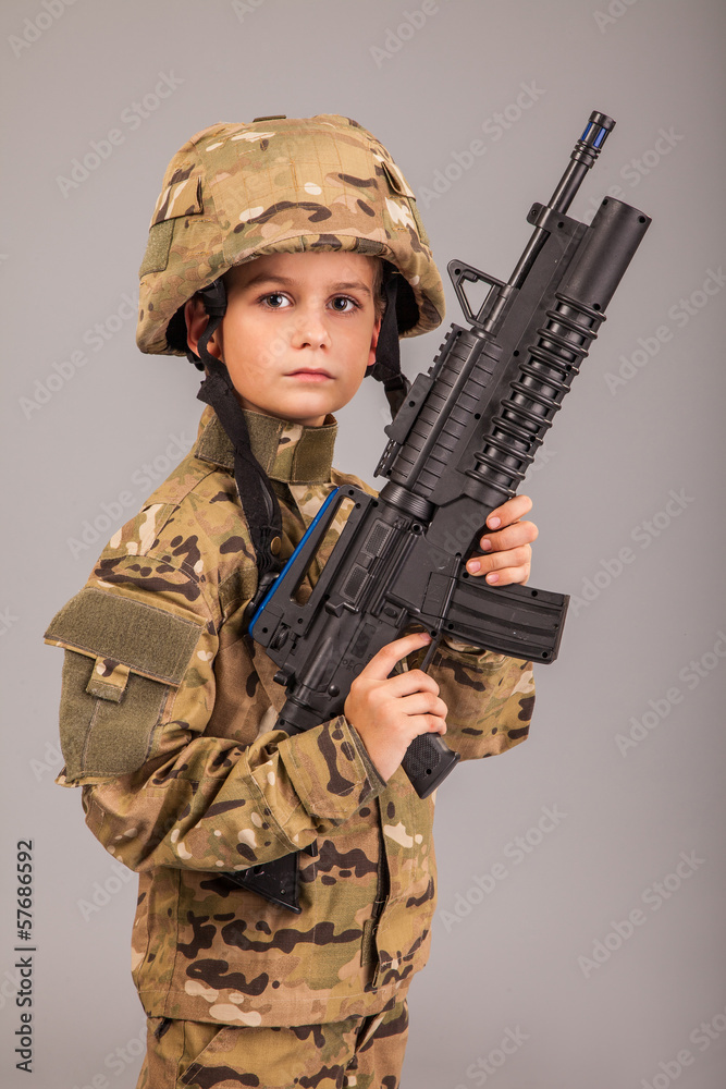 Young boy dressed like a soldier with rifle Young boy dressed like a soldier with rifle