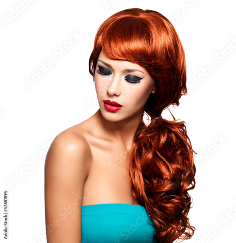 Beautiful woman with long red hairs and bright eye makeup