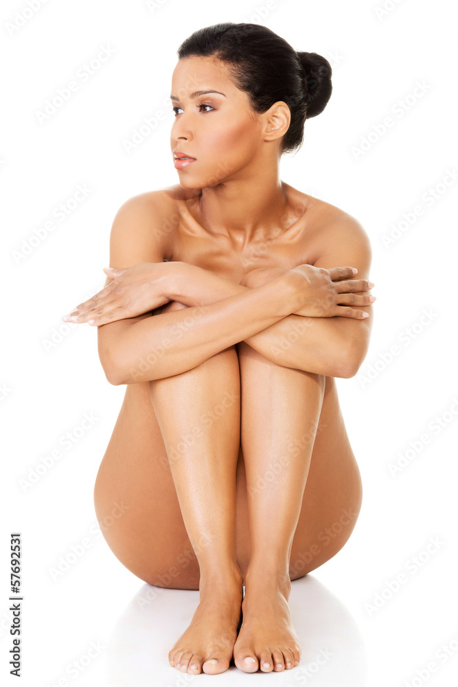 Fototapeta premium Beautiful and naked women sitting and covering her nudity by her