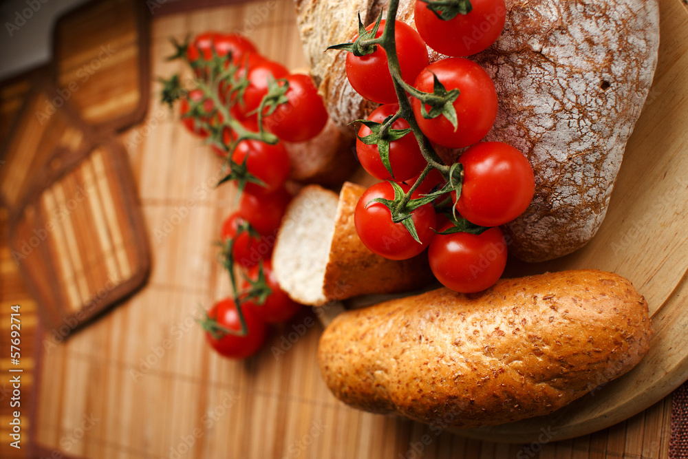 Composition on floured bread and tomatoes Composition on floured bread and tomatoes
