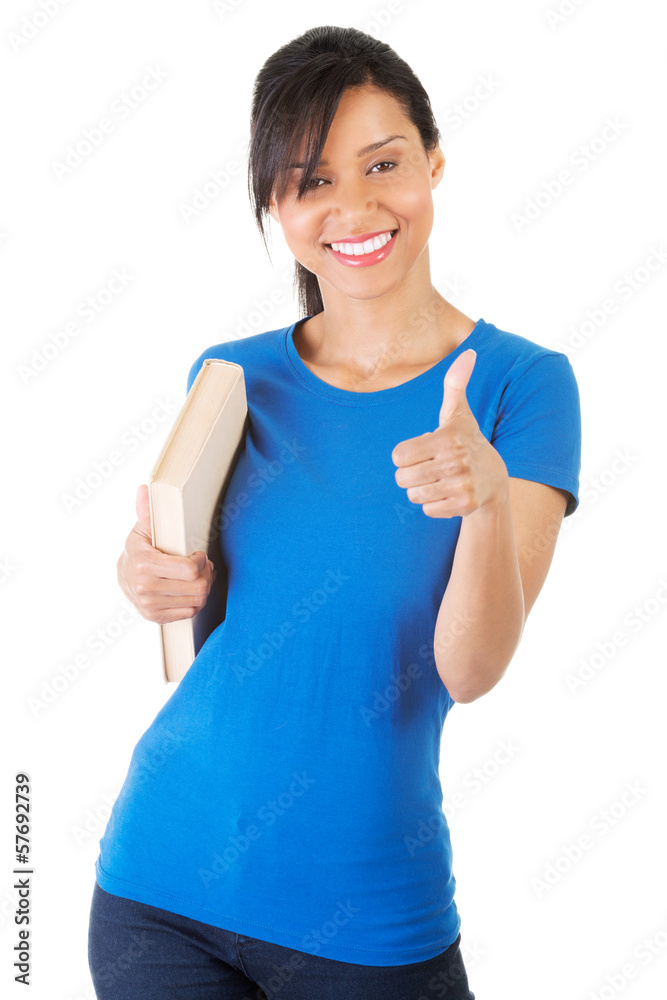 Beautiful young woman with book showing it's all OK. Beautiful young woman with book showing it's all OK.