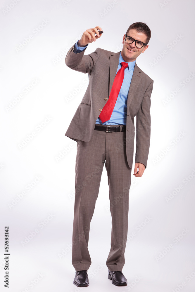 young business man writing on a fictive screen with his marker young business man writing on a fictive screen with his marker