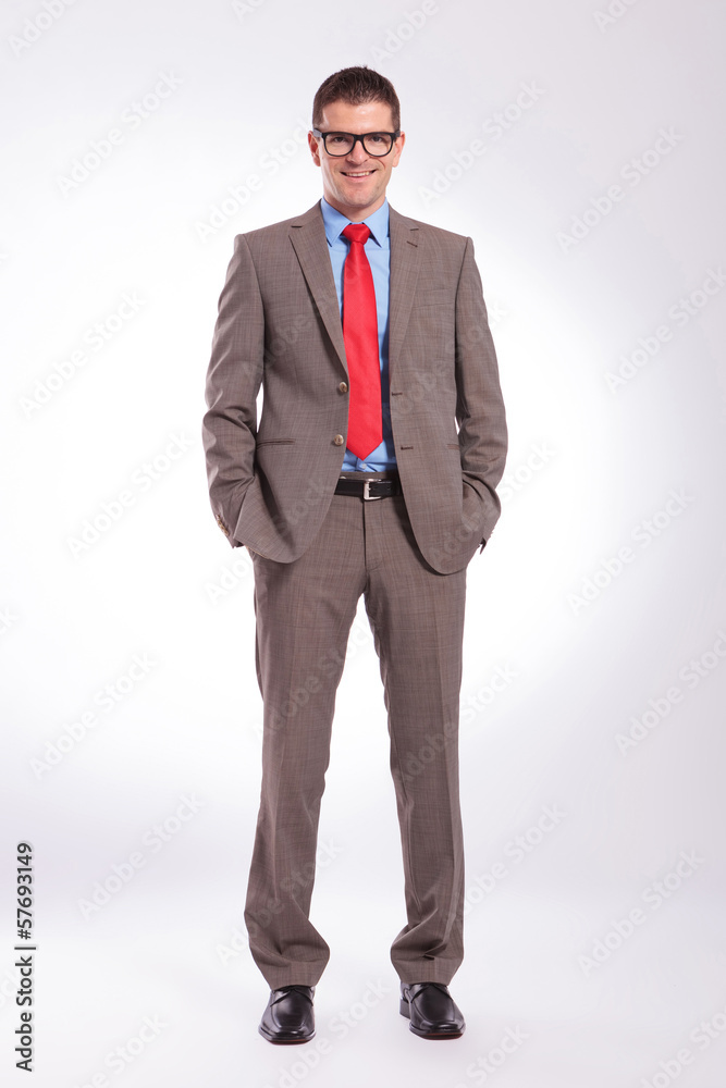 young business man standing with both hands in pockets young business man standing with both hands in pockets