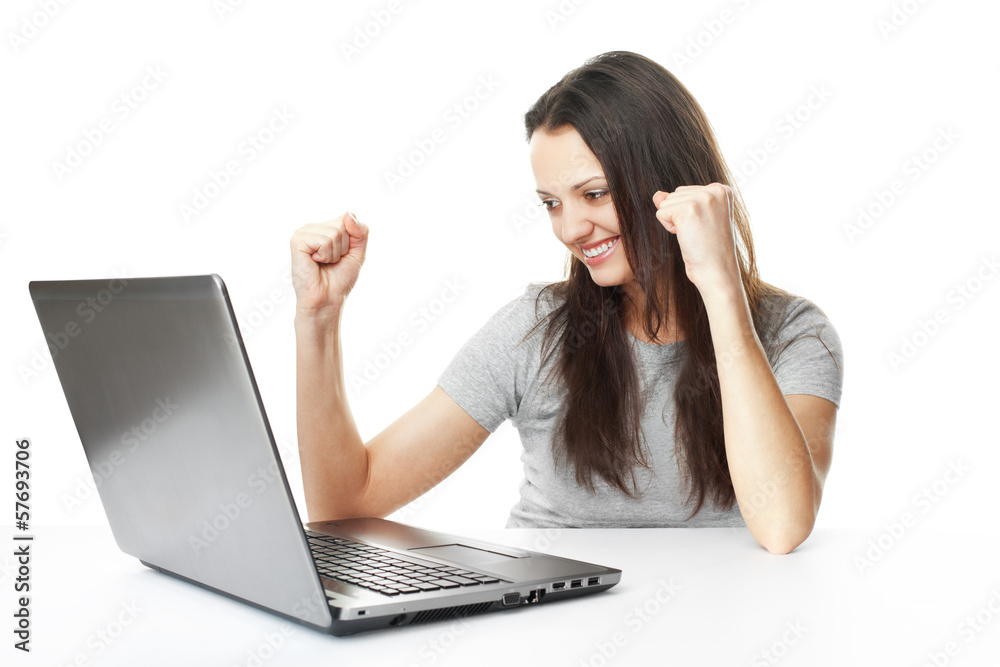 Young woman having success online on her laptop Young woman having success online on her laptop