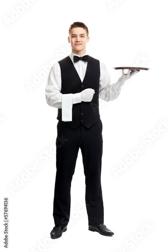 Young smiling waiter with empty tray photo