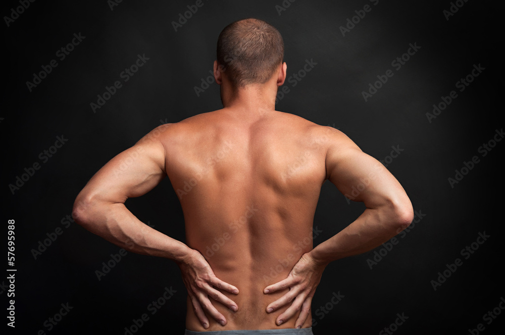 strong man holding his back with hands