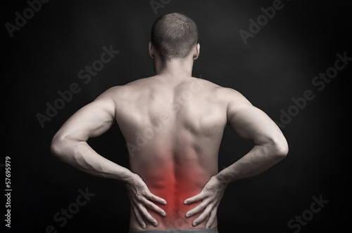 man holding aching back with hands