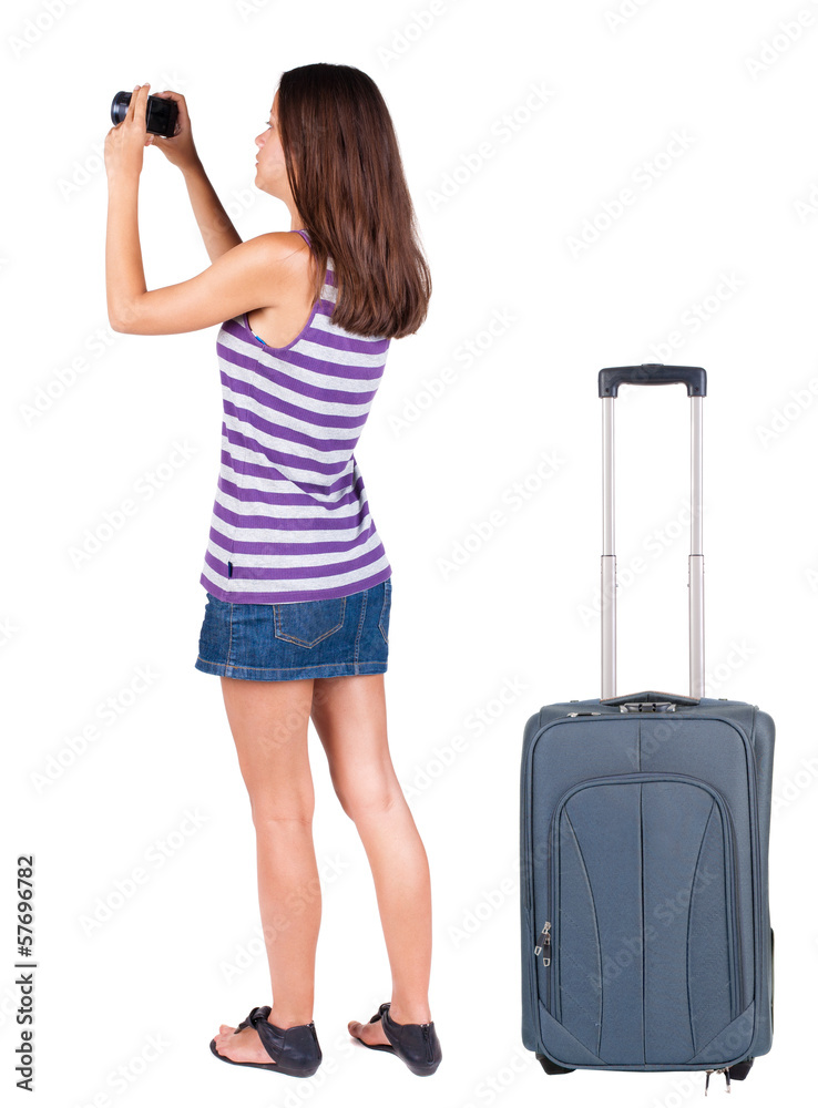 Back view of woman photographing traveling with suitcas. Back view of woman photographing traveling with suitcas.