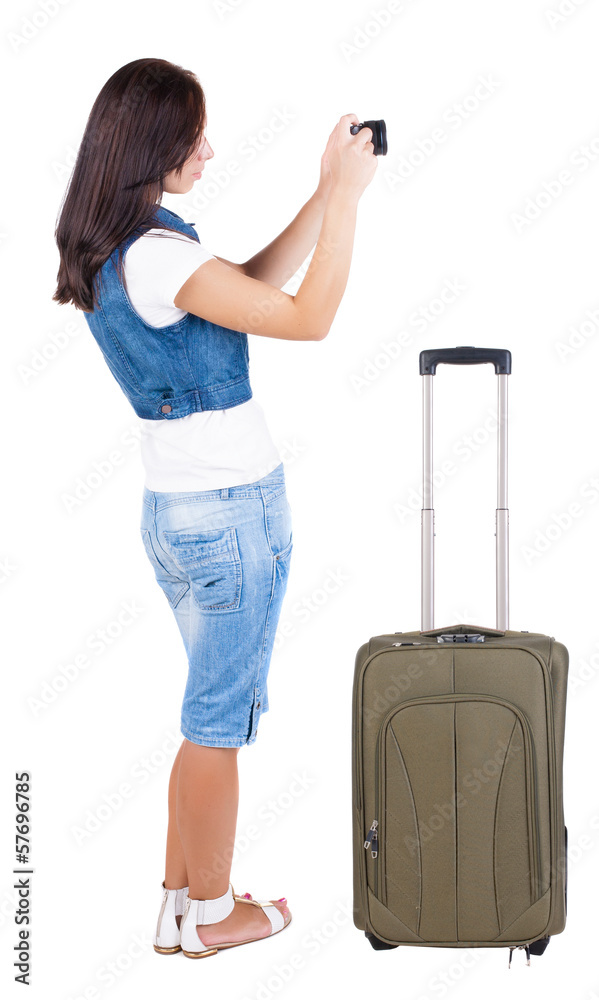 Back view of woman photographing traveling with suitcas. Back view of woman photographing traveling with suitcas.