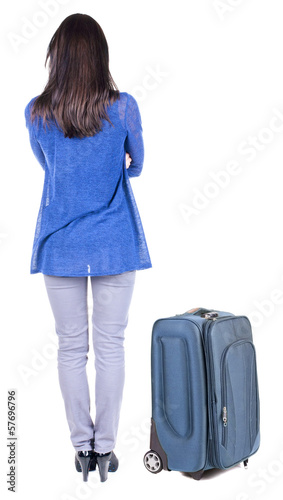 back view of standing young beautiful brunette woman.