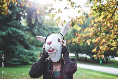 Fototapeta Naklejka Na Ścianę i Meble -  rabbit mask woman listening to music