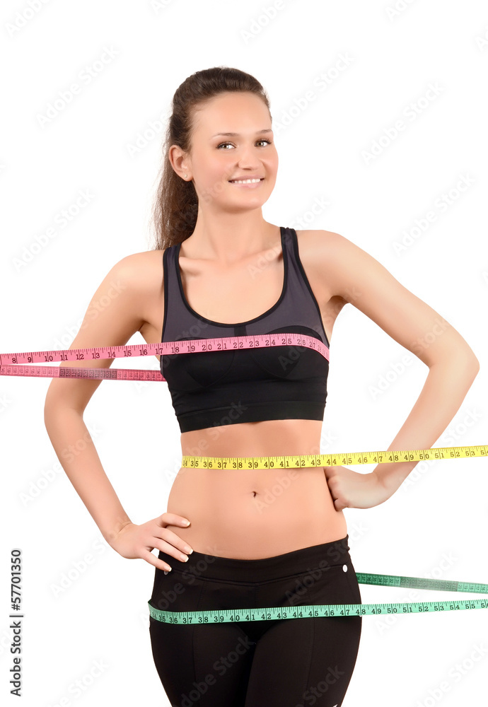 Happy fit girl wrapped with three measuring tapes in inch. Happy fit girl wrapped with three measuring tapes in inch.