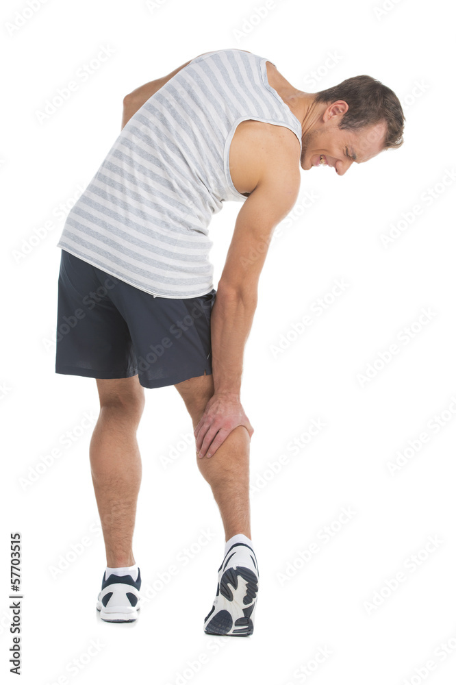 Sportsman feeling pain in his calf. Touching his leg Sportsman feeling pain in his calf. Touching his leg