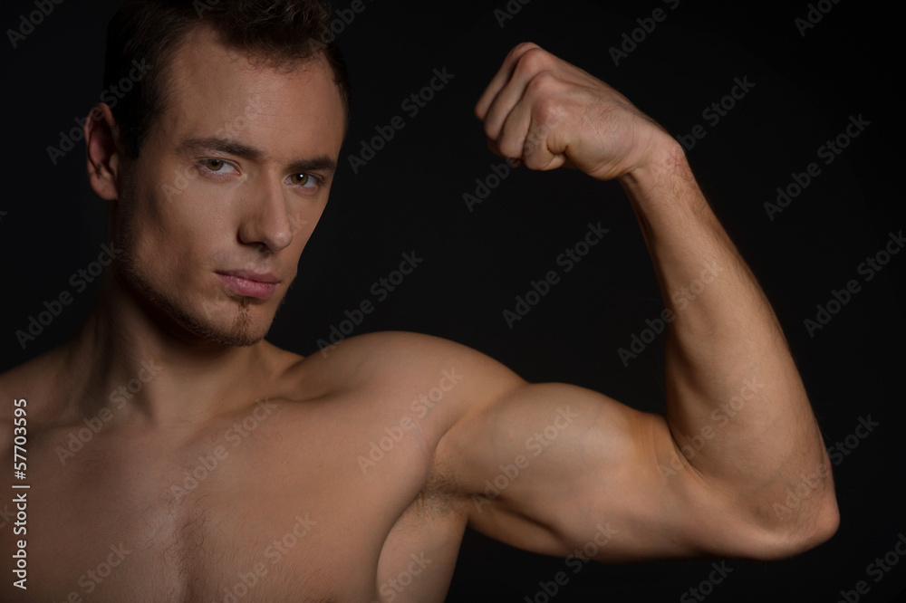 Handsome man showing his muscles. Handsome man showing his muscles.