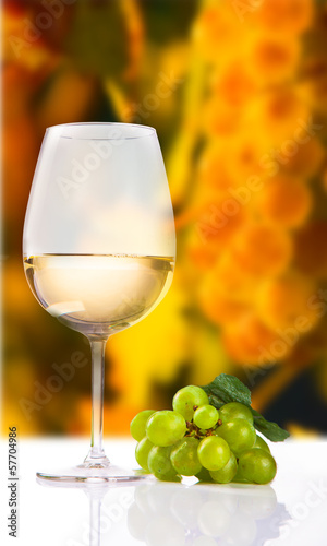 wineglass with white wine and grape