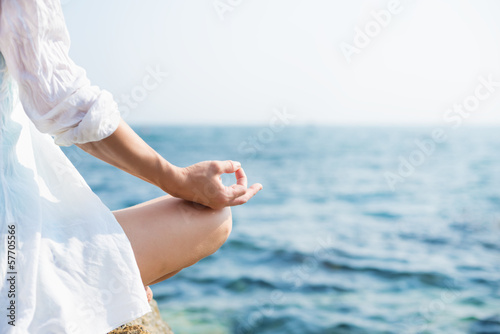 Fototapeta Naklejka Na Ścianę i Meble -  Woman meditating at the sea