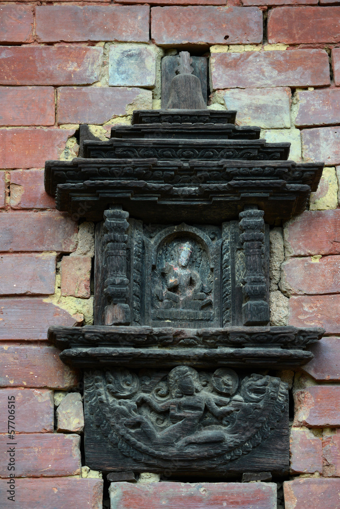 Carved wooden details on a brick wall