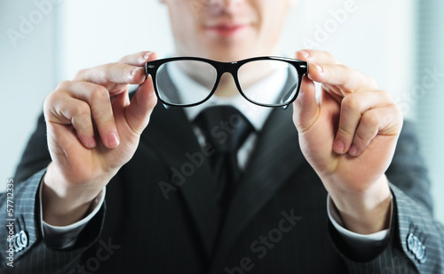 Close up of a man holds glasses