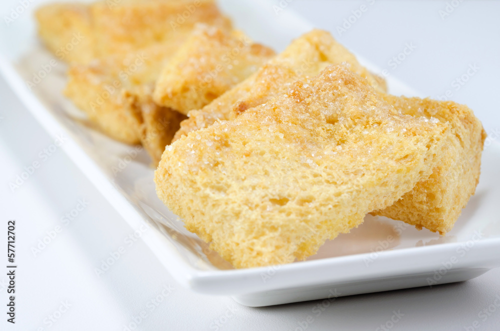 mini toasts with sugar close up on a white background