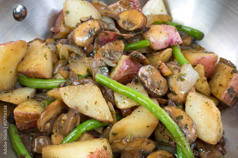 A very close view of vegetables cooking in a skillet A very close view of vegetables cooking in a skillet