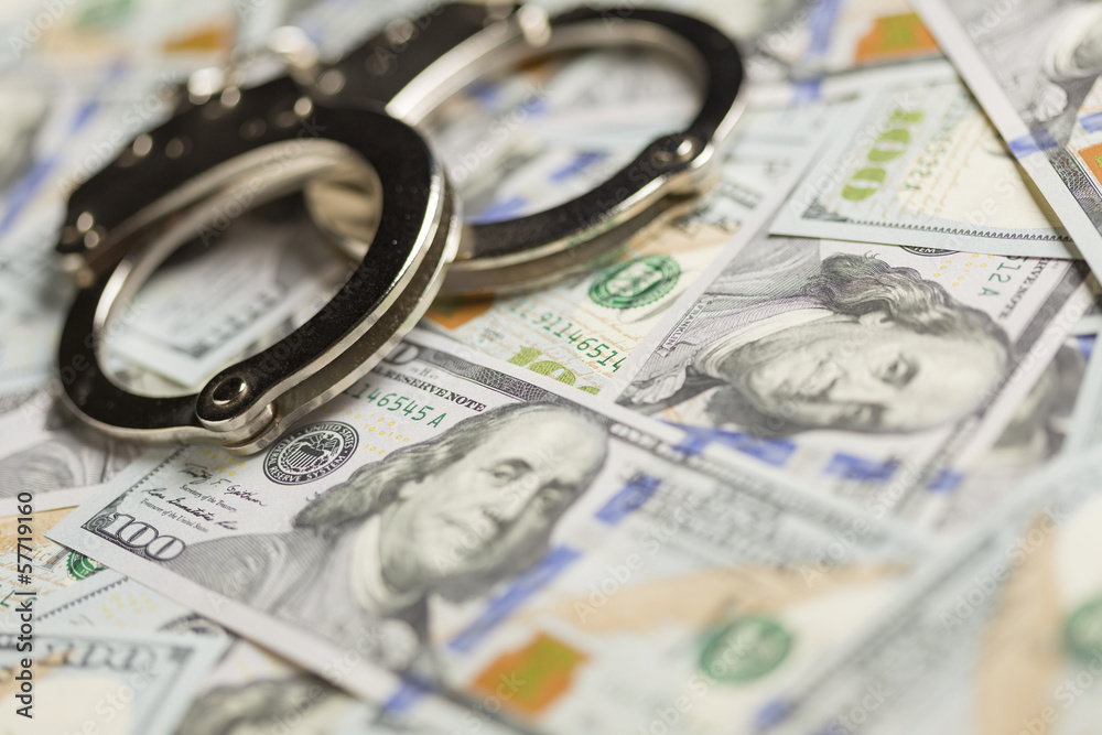 Handcuffs and Newly Designed One Hundred Dollar Bills Handcuffs and Newly Designed One Hundred Dollar Bills