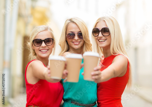 women with takeaway coffee cups in the city