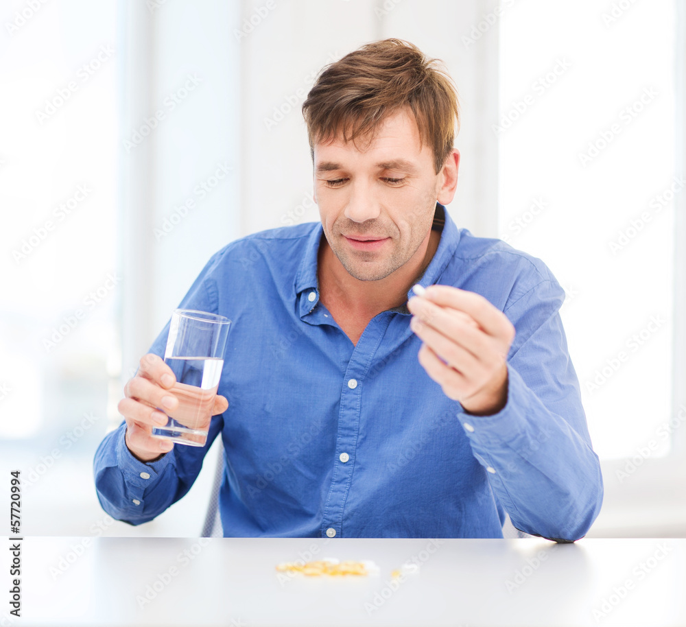 ill man taking his pills at home